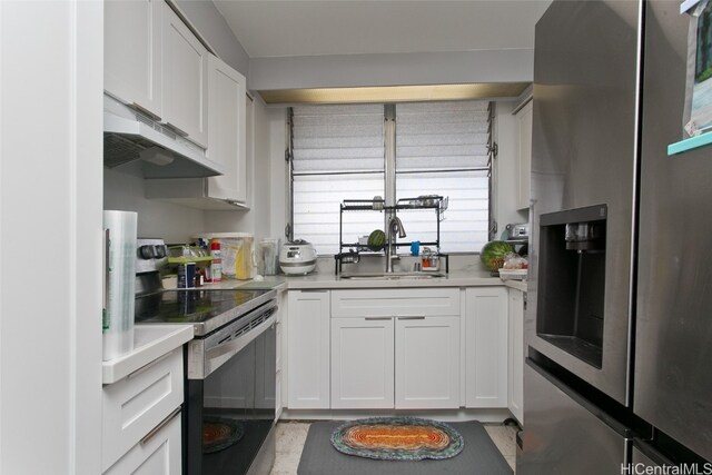 kitchen with white cabinetry, stainless steel appliances, sink, and a wealth of natural light