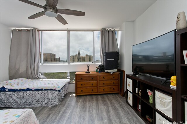 bedroom featuring wood-type flooring and ceiling fan