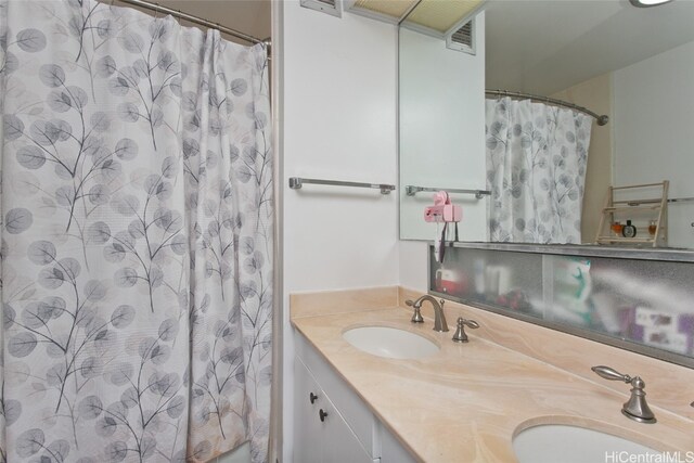 bathroom featuring vanity and a shower with shower curtain