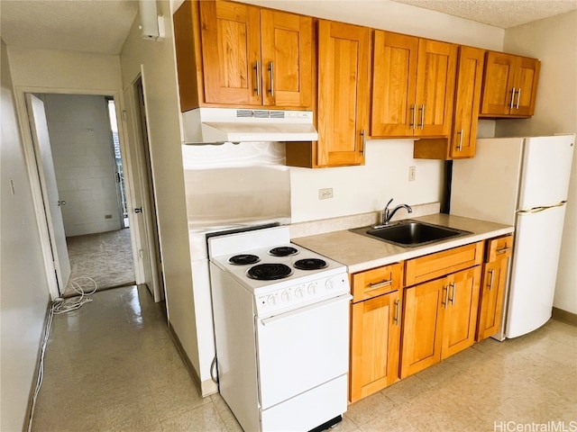 kitchen featuring white appliances, a textured ceiling, and sink