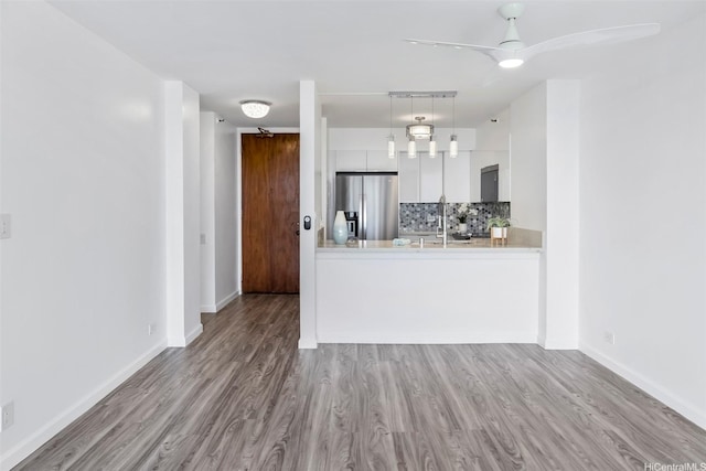 322 Aoloa St Unit Ph-9, Kailua, HI 96734 - kitchen featuring backsplash, stainless steel refrigerator with ice dispenser, wood finished floors, light countertops, and white cabinets