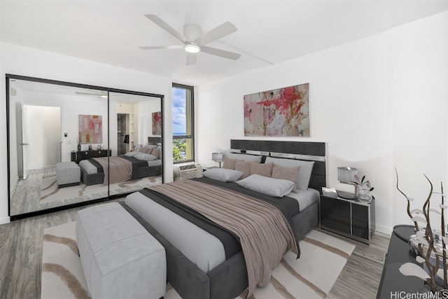 bedroom with a closet, ceiling fan, and light wood-type flooring