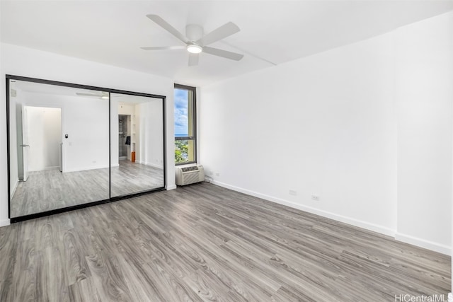 unfurnished bedroom featuring light hardwood / wood-style flooring, a closet, and ceiling fan