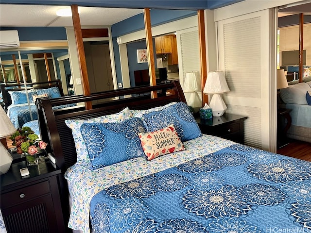 bedroom with wood-type flooring and a wall unit AC