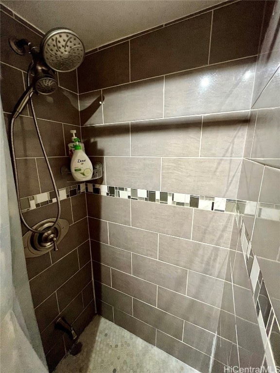 bathroom with a tile shower