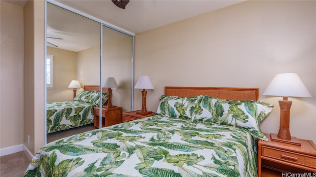 carpeted bedroom featuring a closet and ceiling fan