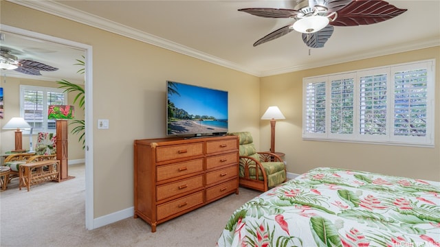 carpeted bedroom featuring ceiling fan and crown molding