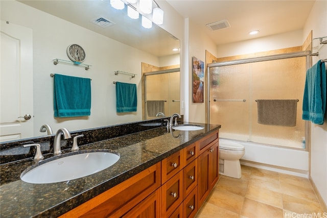 full bathroom with toilet, vanity, shower / bath combination with glass door, and tile patterned flooring