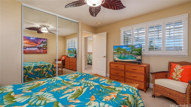 carpeted bedroom with a closet and ceiling fan