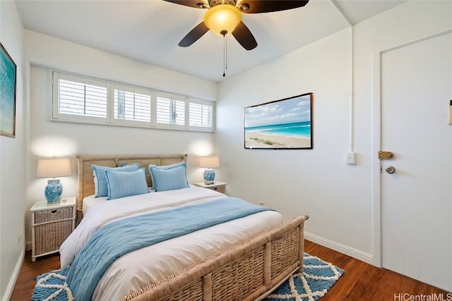 bedroom with multiple windows, dark hardwood / wood-style floors, and ceiling fan