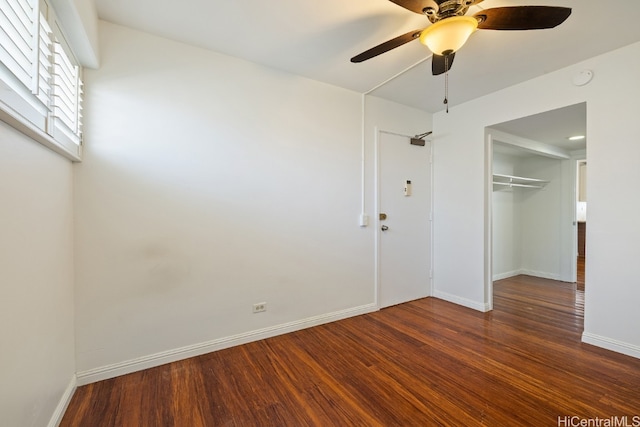 unfurnished bedroom featuring dark hardwood / wood-style floors, a closet, and ceiling fan