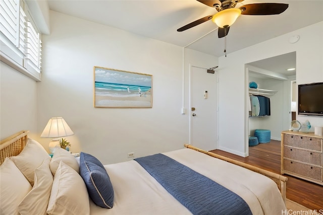 bedroom with hardwood / wood-style flooring, a closet, and ceiling fan