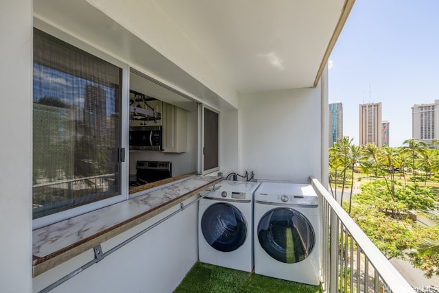 balcony with washer and clothes dryer