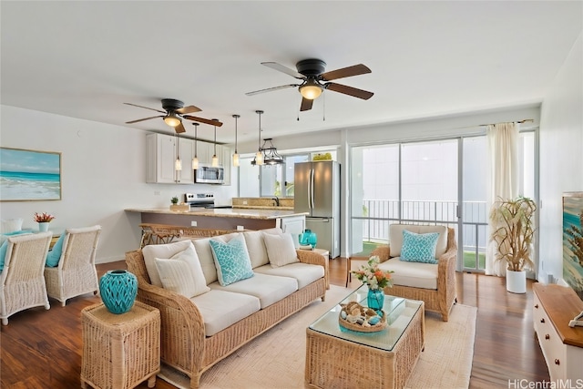 living room with wood-type flooring and ceiling fan