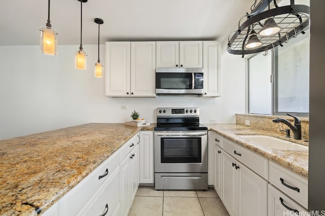 kitchen with white cabinetry, light tile patterned floors, stainless steel appliances, and sink