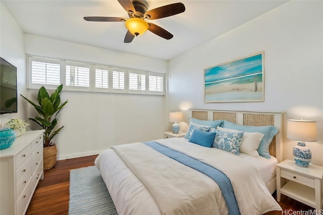 bedroom with dark hardwood / wood-style floors and ceiling fan