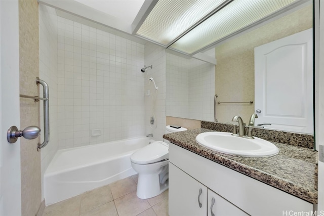 full bathroom featuring toilet, tiled shower / bath combo, vanity, and tile patterned flooring