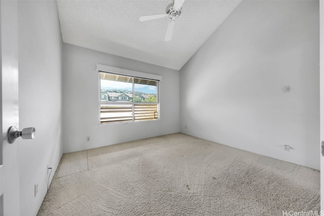 carpeted empty room featuring ceiling fan, a textured ceiling, and lofted ceiling