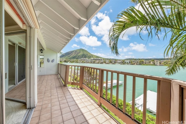 balcony featuring a water and mountain view