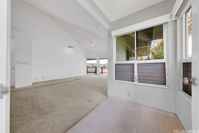 empty room featuring light carpet, lofted ceiling, and ceiling fan