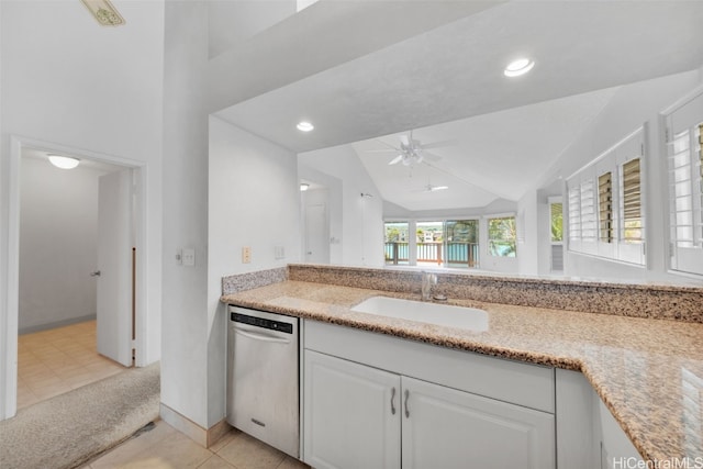 kitchen featuring lofted ceiling, white cabinets, ceiling fan, stainless steel dishwasher, and sink