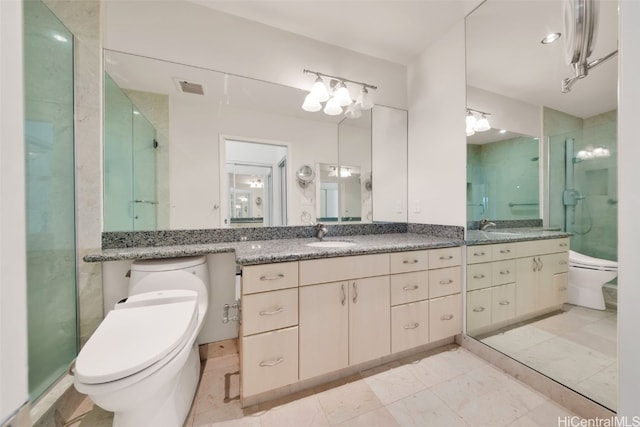 bathroom with vanity, toilet, and an enclosed shower