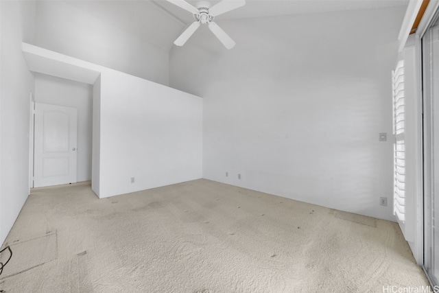 spare room featuring light carpet and ceiling fan