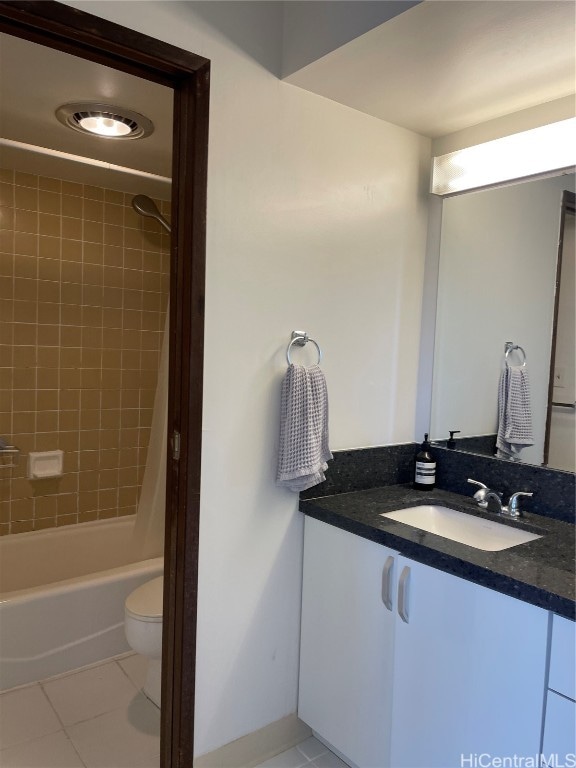 full bathroom featuring vanity, tiled shower / bath combo, toilet, and tile patterned flooring