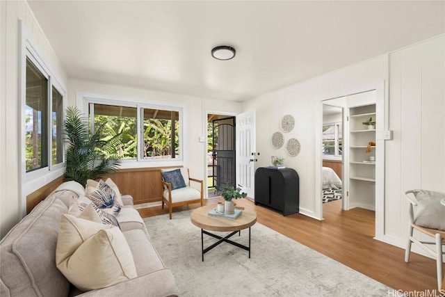 living area with wood finished floors and baseboards