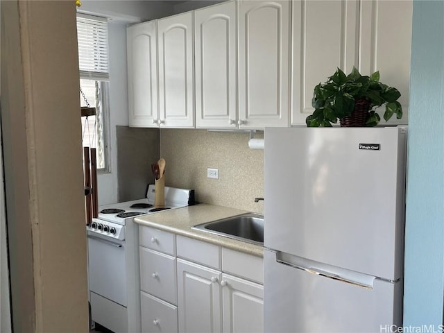 kitchen featuring white cabinetry, sink, white appliances, and decorative backsplash