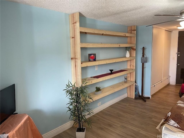 interior space with ceiling fan and baseboard heating