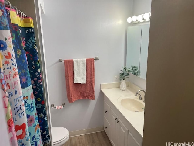 bathroom featuring hardwood / wood-style floors, toilet, vanity, and a shower with shower curtain