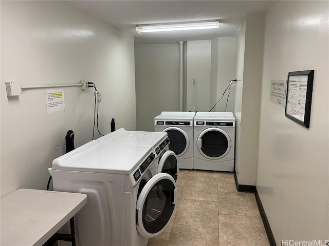 laundry area featuring light tile patterned floors and independent washer and dryer