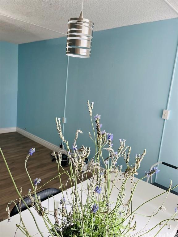 details with wood-type flooring and a textured ceiling