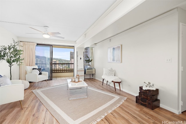 living room with hardwood / wood-style floors and ceiling fan