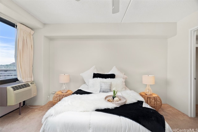 carpeted bedroom with a textured ceiling and ceiling fan