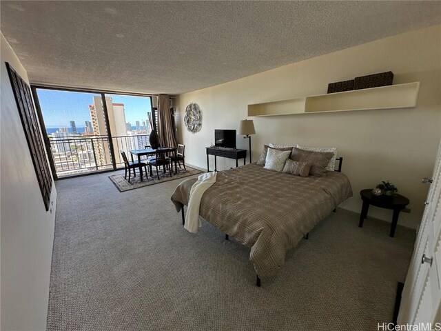 bedroom with access to exterior, carpet floors, floor to ceiling windows, and a textured ceiling