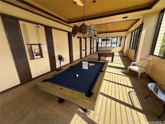 playroom featuring baseboards, a raised ceiling, and dark colored carpet