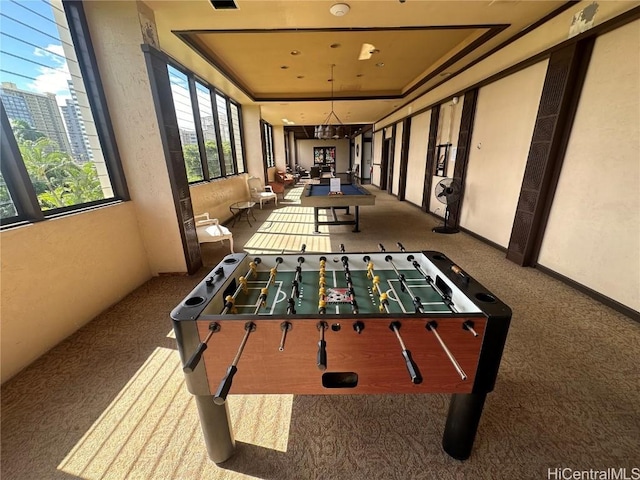 game room featuring a view of city, carpet flooring, a raised ceiling, and visible vents