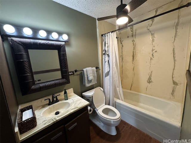 bathroom featuring shower / bathtub combination with curtain, toilet, a textured ceiling, vanity, and wood finished floors