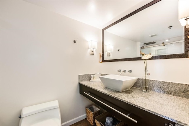 bathroom with vanity, hardwood / wood-style flooring, and toilet