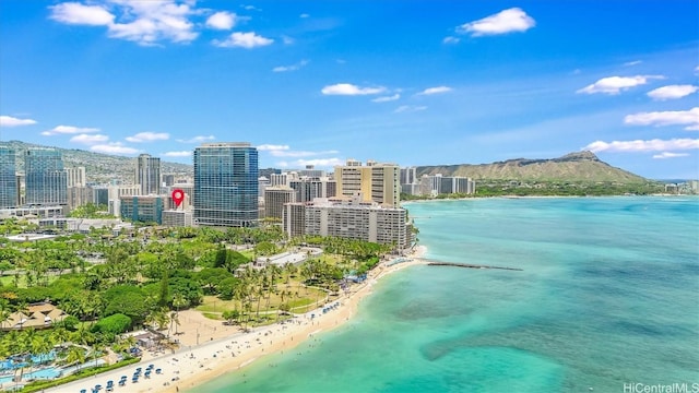 birds eye view of property featuring a view of the beach and a water and mountain view