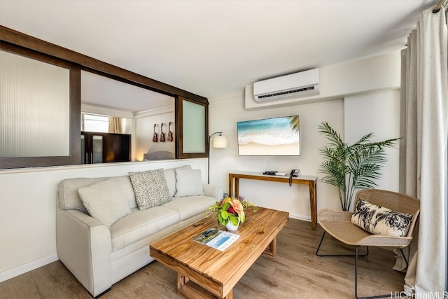 living room with an AC wall unit and light hardwood / wood-style flooring