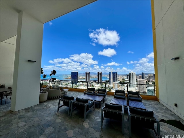 view of patio / terrace with a balcony and a water view