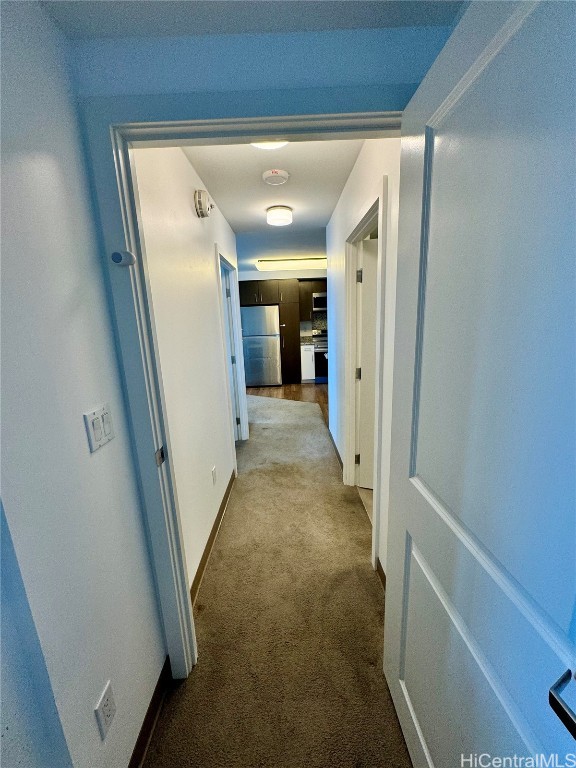 hallway with light colored carpet