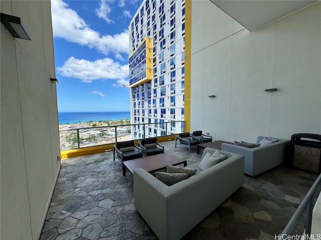 view of patio with an outdoor living space, a beach view, a water view, and a balcony