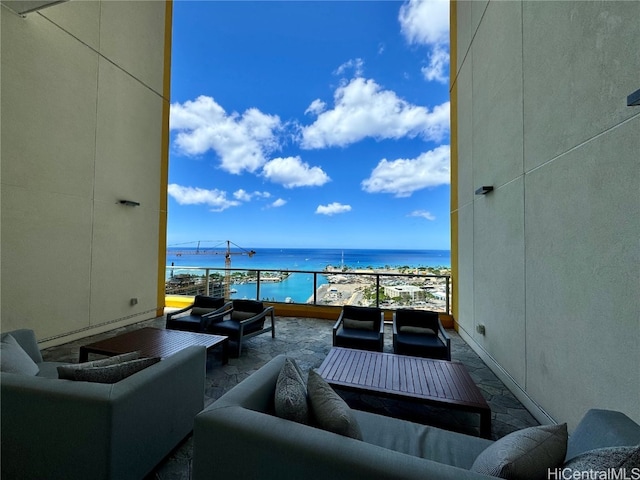 balcony with a water view and an outdoor living space