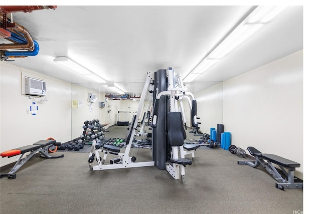 exercise room featuring a wall unit AC