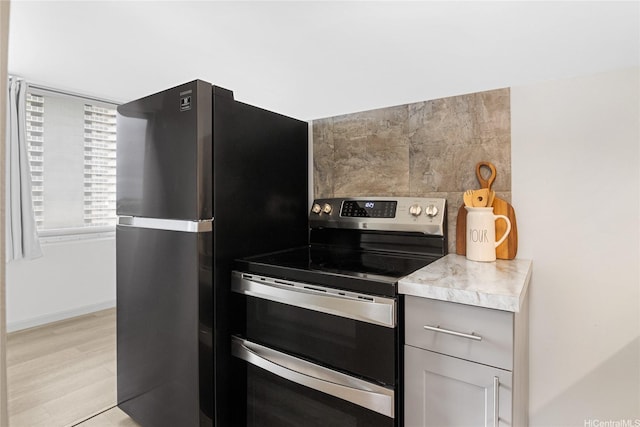 98-288 Kaonohi St Unit 703, Aiea, HI 96701 - kitchen with stainless steel appliances, light countertops, light wood-style floors, baseboards, and gray cabinetry