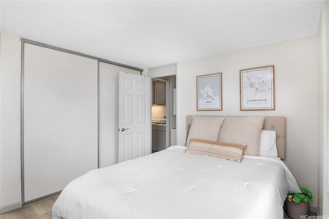 bedroom with a closet and light wood-style flooring